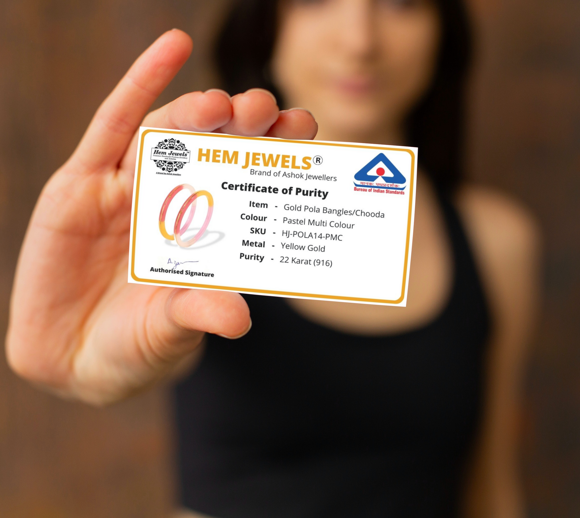 "Woman holding the certificate of authenticity for Handmade 22kt (916) Yellow Gold Pola Bangles."