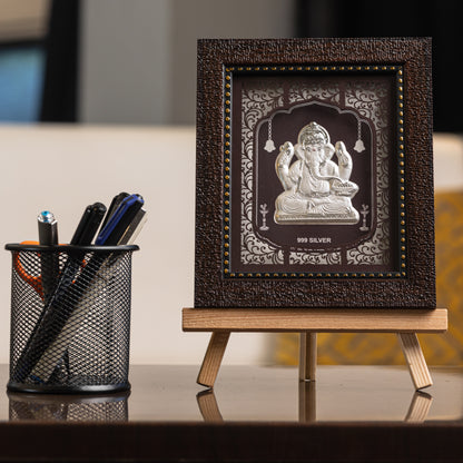 "Front view of pure silver  Ganesh frame by Hem Jewels® placed on a table."