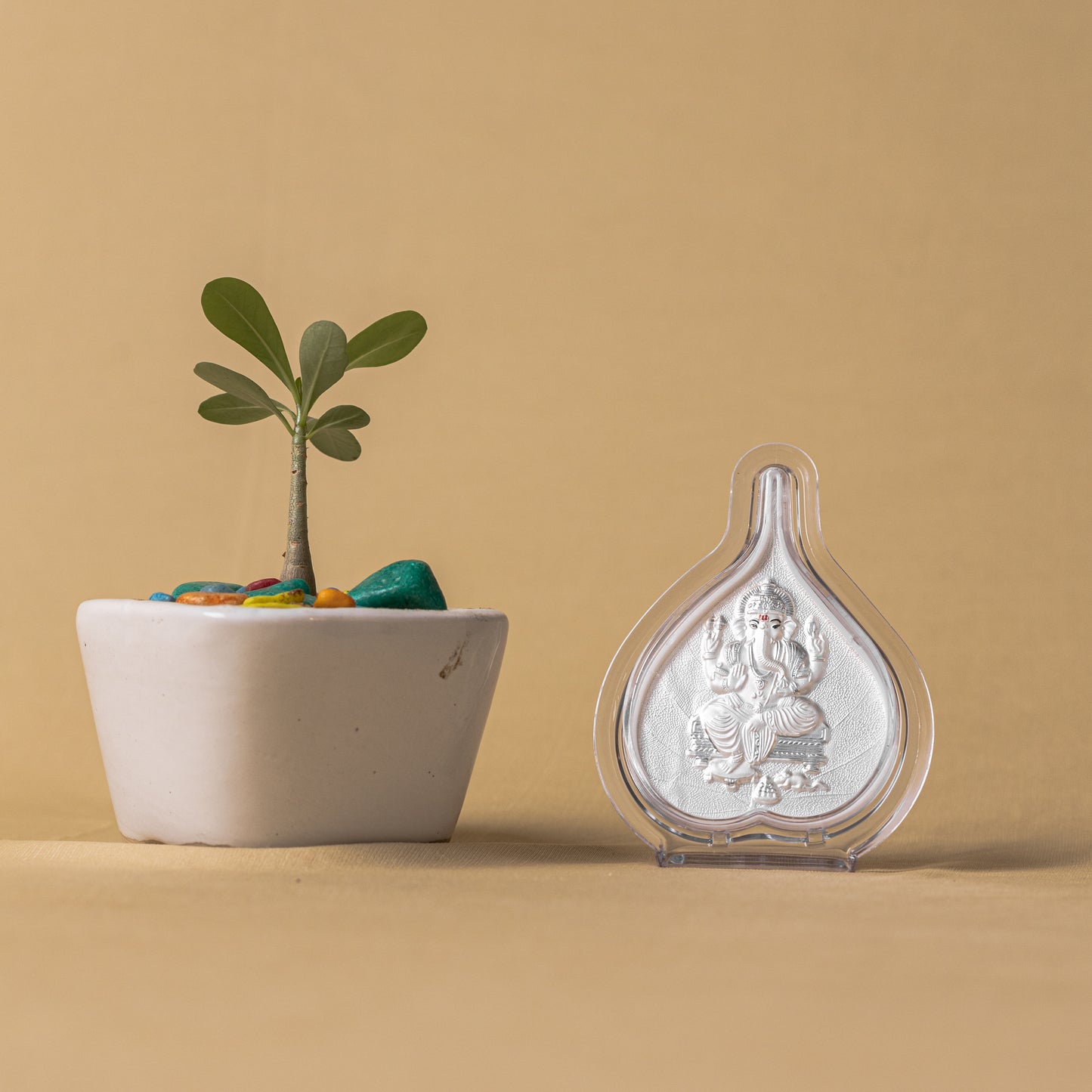 "Angled view of the pure silver Ganesh frame by Hem Jewels® placed on a wooden table."