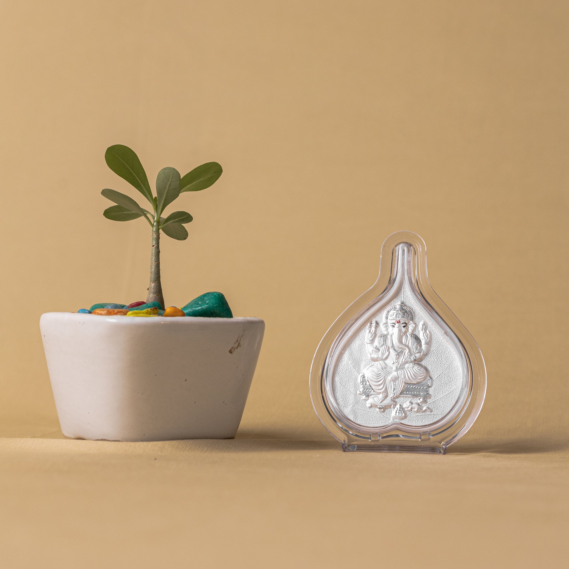 "Angled view of the pure silver Ganesh frame by Hem Jewels® placed on a wooden table."