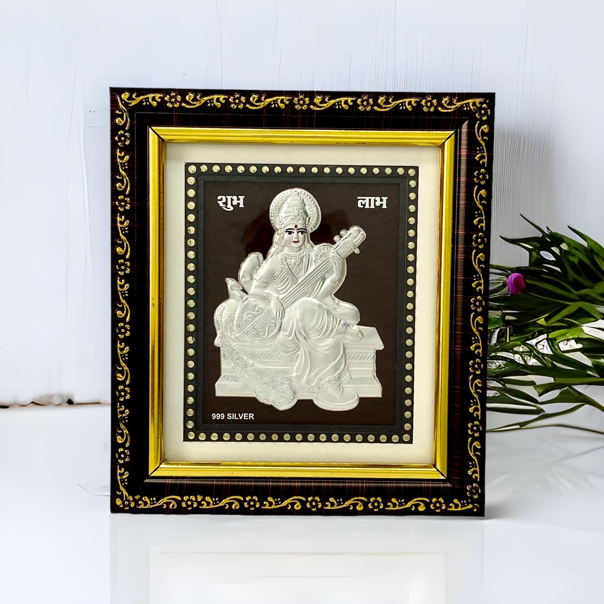 "Front view of pure silver Saraswati frame by Hem Jewels® placed on a table."	