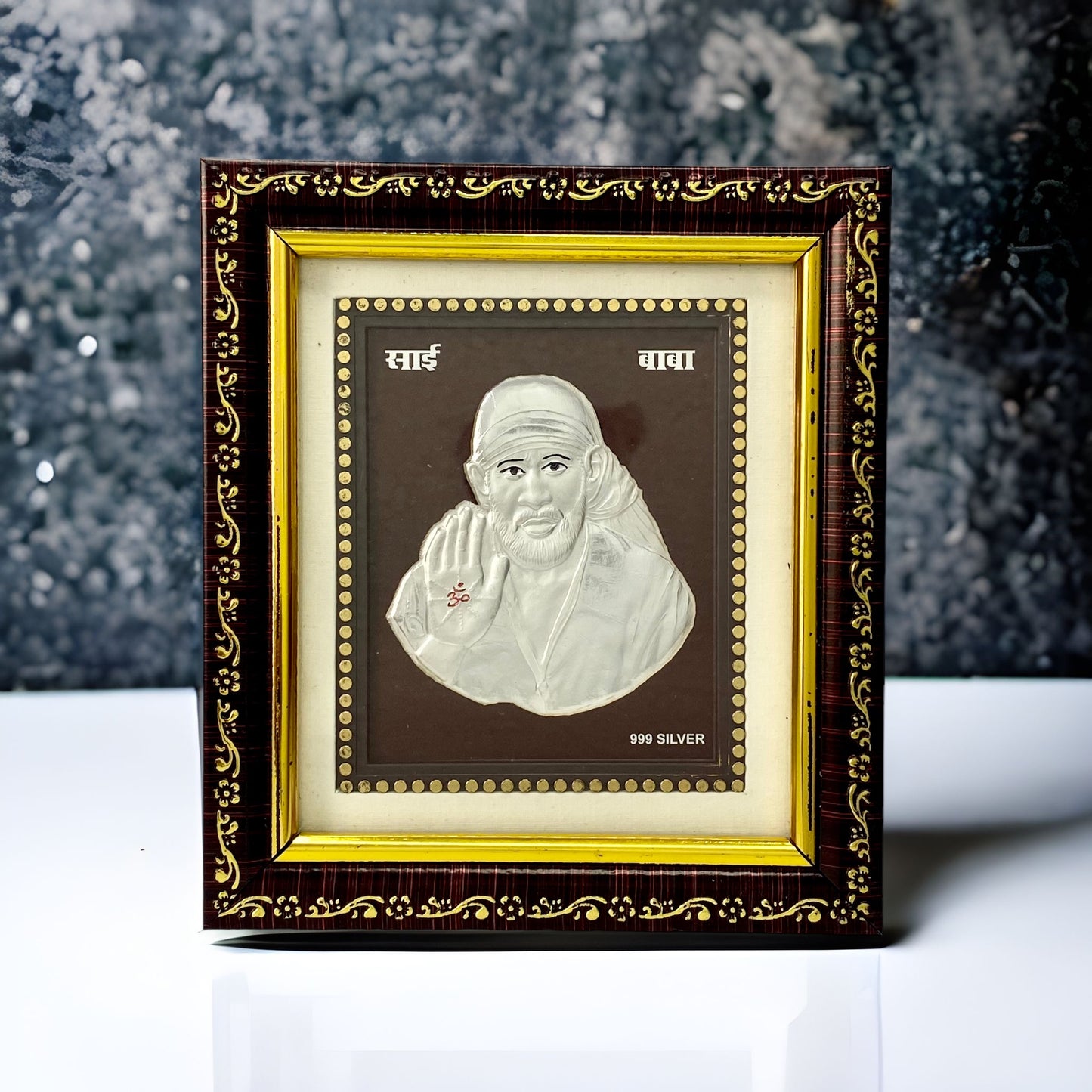 "Front view of pure silver Sai Baba frame by Hem Jewels® placed on a table."	