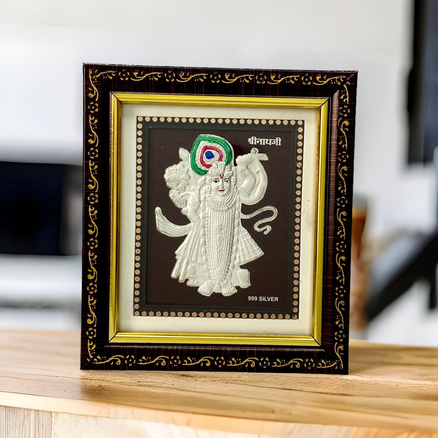 "Front view of pure silver Shreenathji frame by Hem Jewels® placed on a table."	