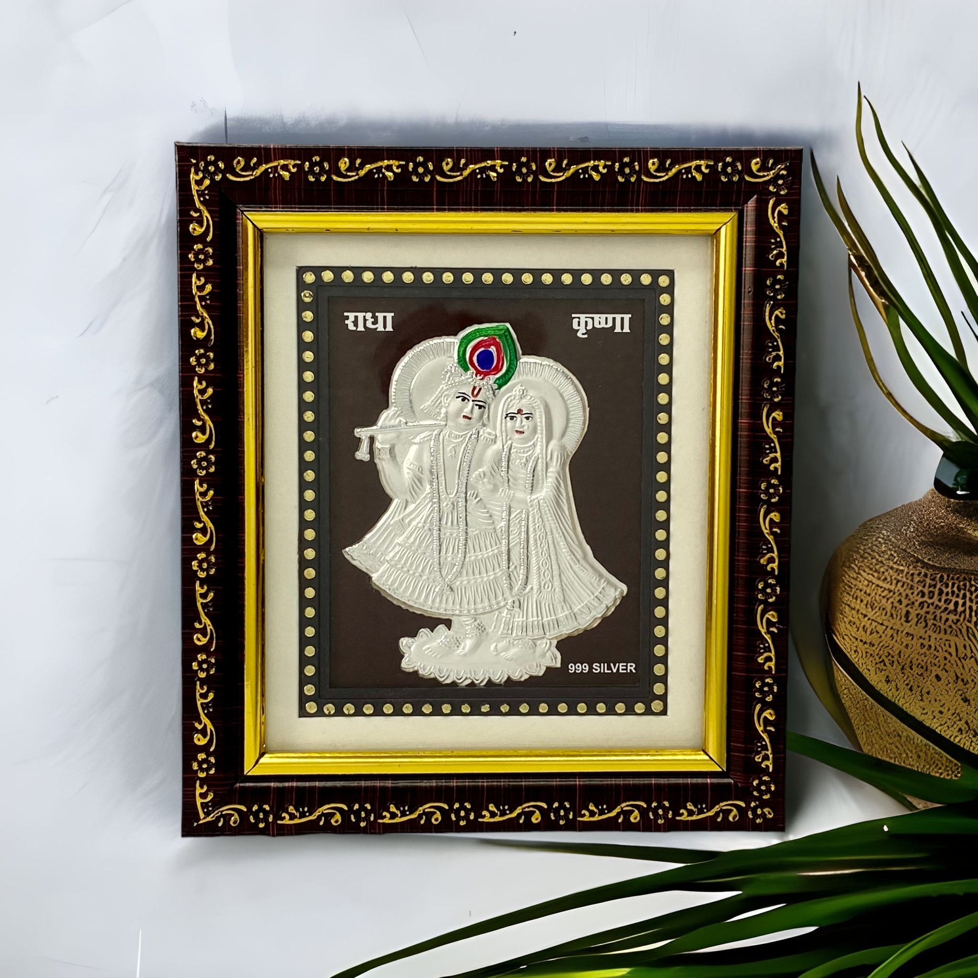 "Front view of pure silver Radhe Krishna frame by Hem Jewels® placed on a table."	