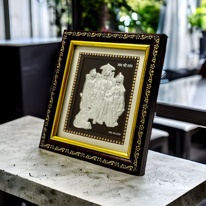 "Angled view of the pure silver Ram Darbar frame by Hem Jewels® placed on a wooden table."	