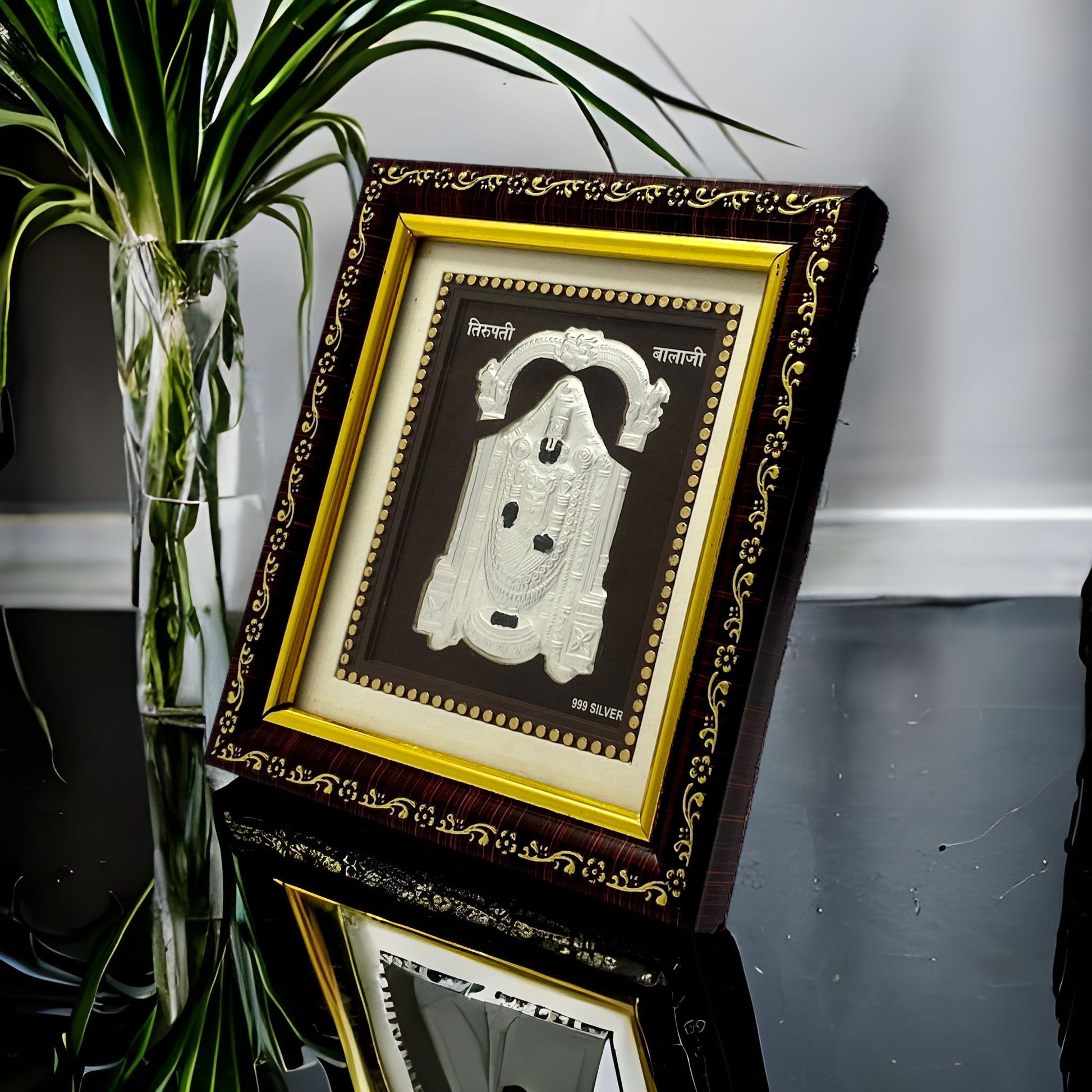 "Angled view of the pure silver Tirupathi Balaji frame by Hem Jewels® placed on a wooden table."	