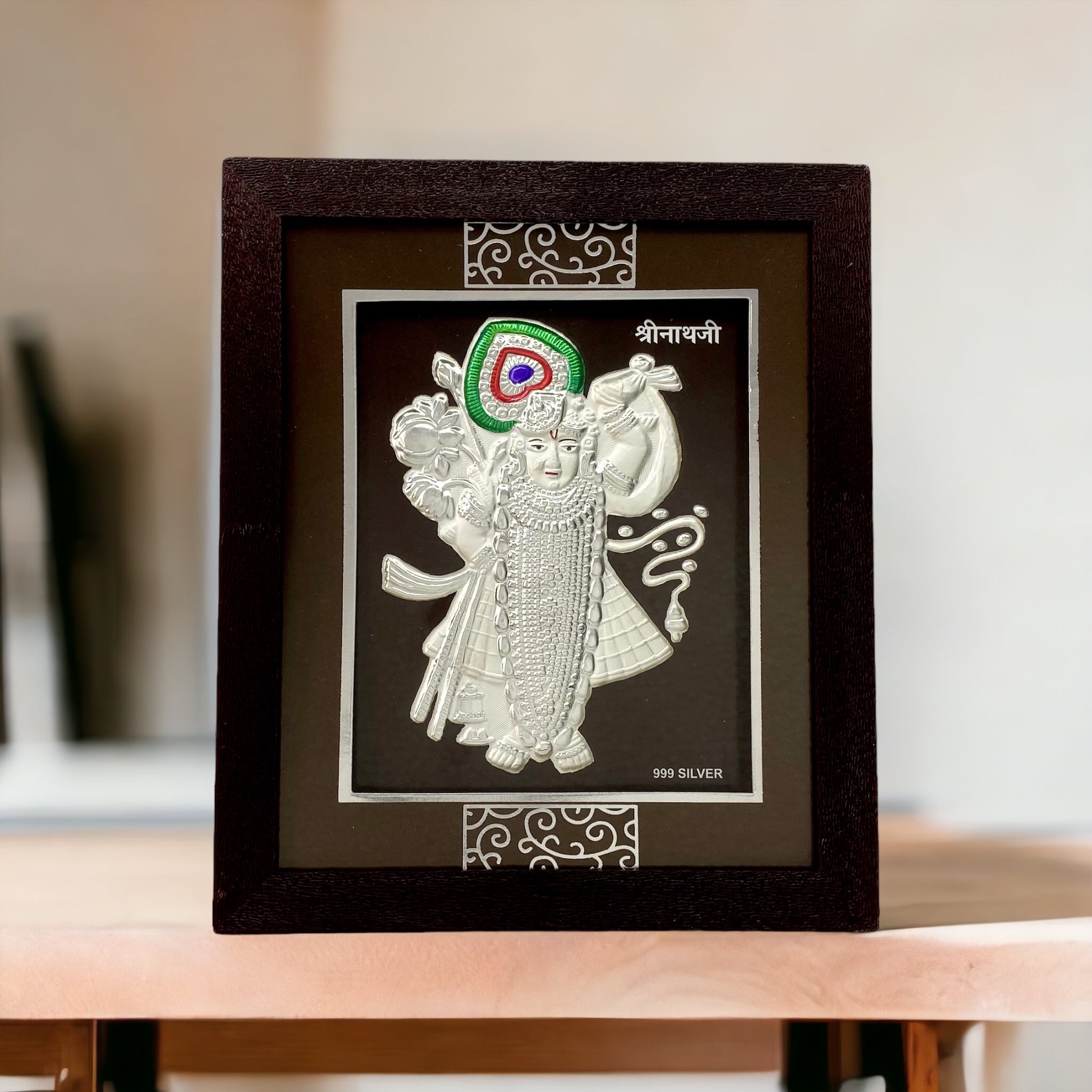 "Front view of pure silver Shreenathji frame by Hem Jewels® placed on a table."	