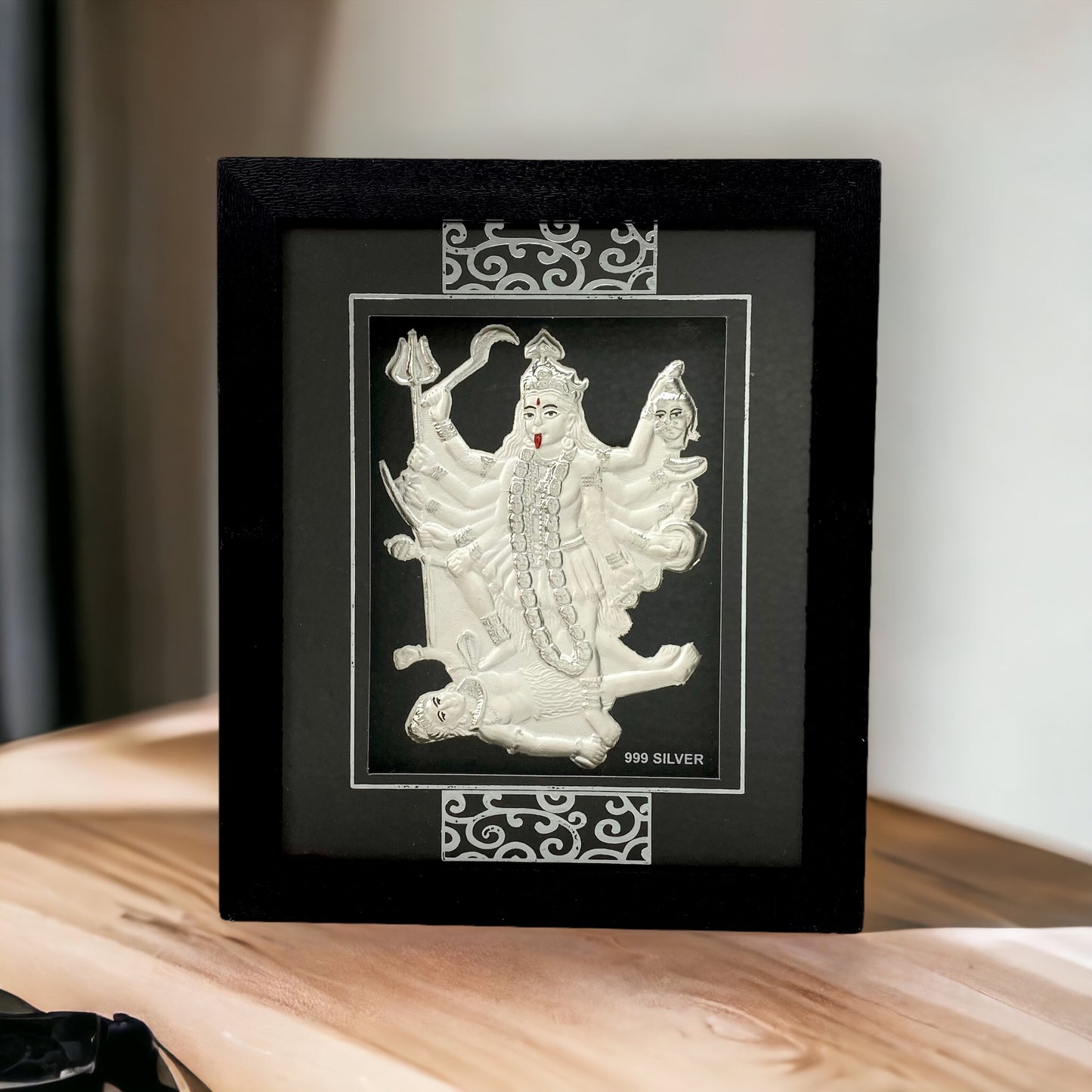 "Front view of pure silver Mahakali frame by Hem Jewels® placed on a table."	