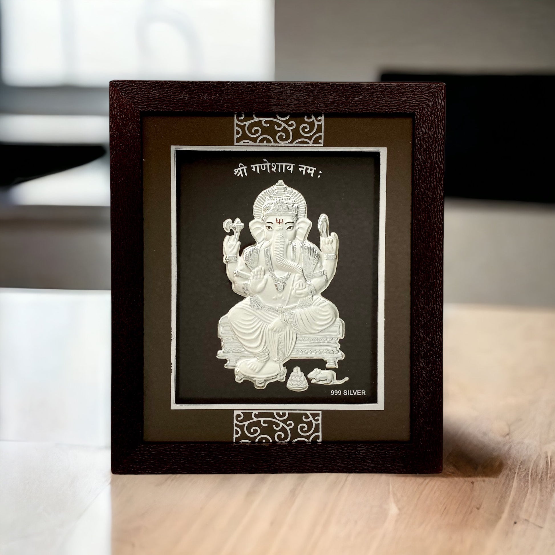 "Front view of pure silver Ganesh frame by Hem Jewels® placed on a table."