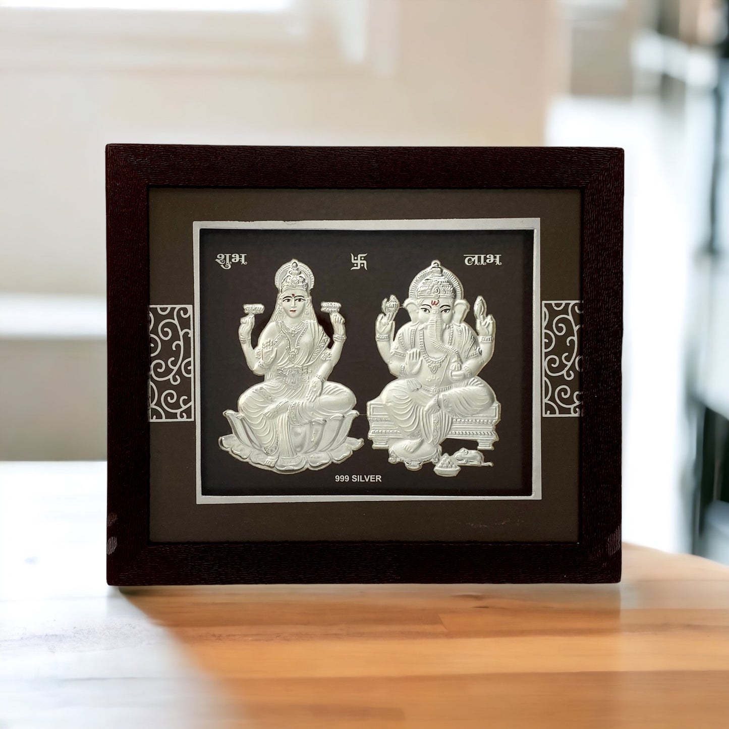 "Front view of pure silver Ganesh Laxmi frame by Hem Jewels® placed on a table."	