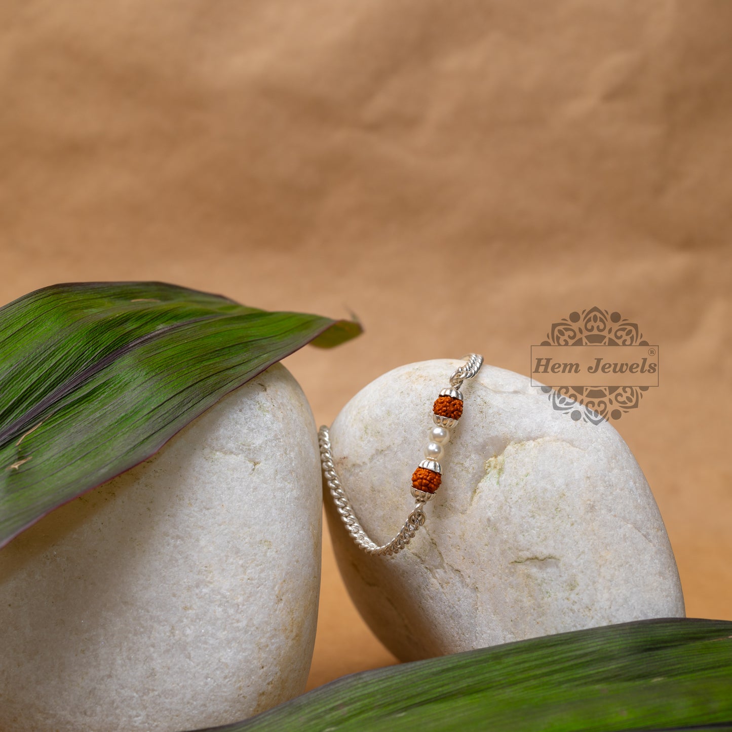 Silver Rakhi with 2 Lustrous Pearls between 2 Rudraksh Beads Motif - Motif Close Up