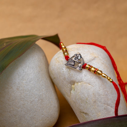 Artisanal Silver Rakhi with Ganesh with Shivling Motif - Motif Close Up