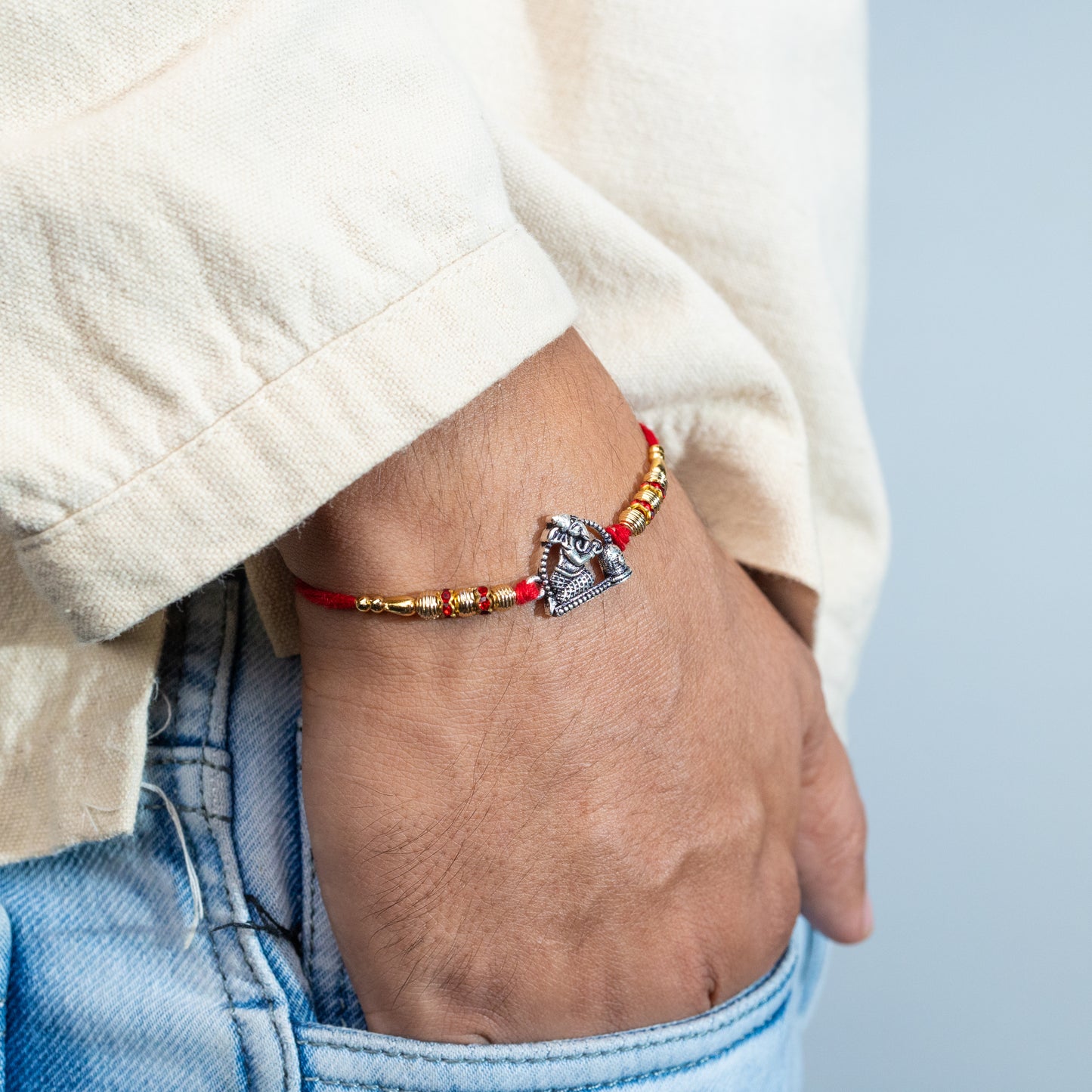 A man Artisanal Silver Rakhi  with Ganesh with Shivling Motif