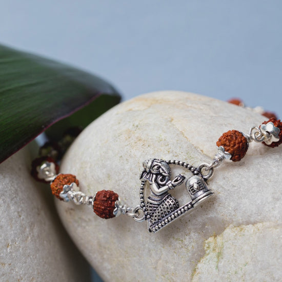 Video showing Silver Rudraksha Rakhi with Ganesh & Shivling Motif and its use.