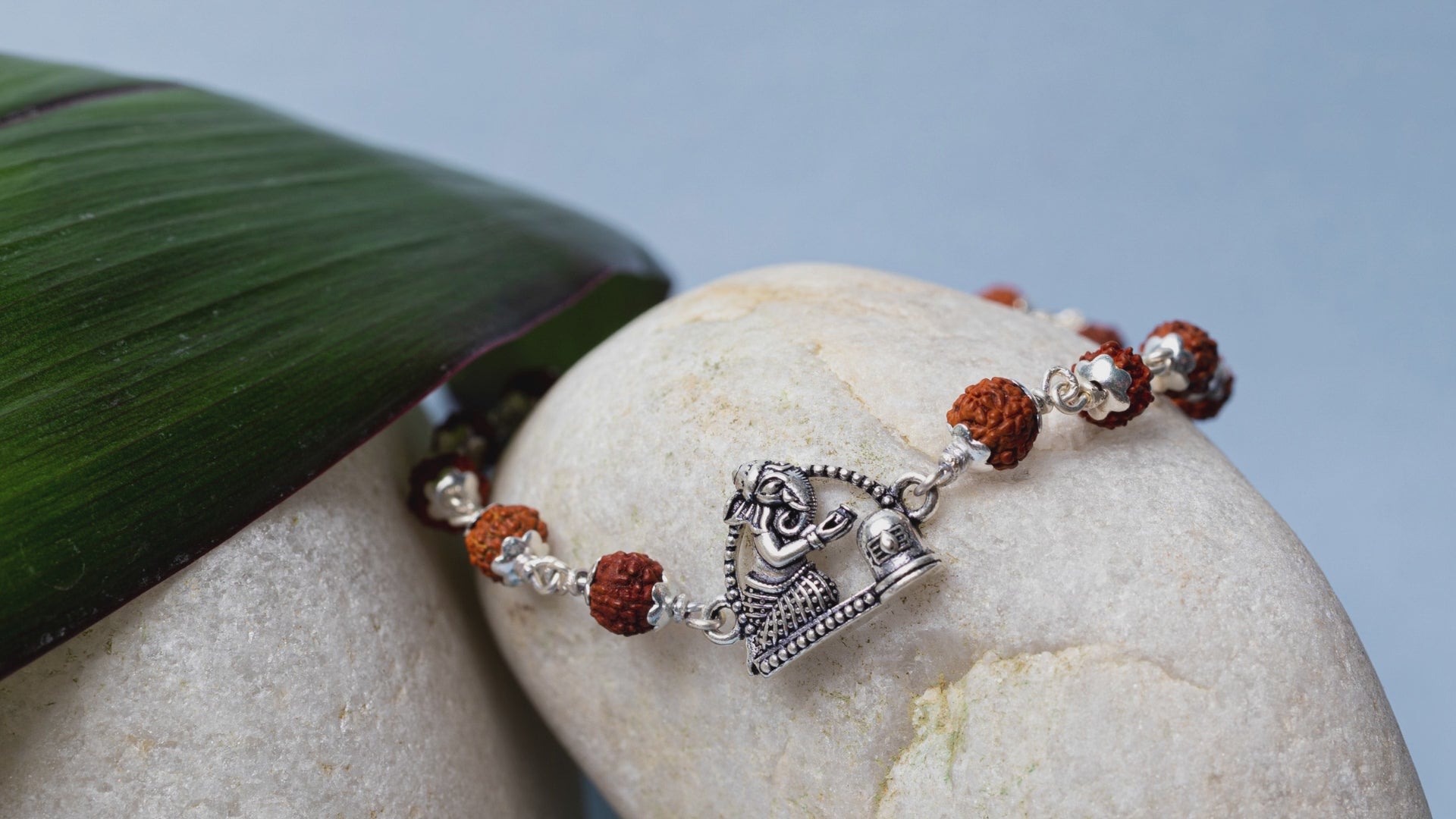 Video showing Silver Rudraksha Rakhi with Ganesh & Shivling Motif and its use.