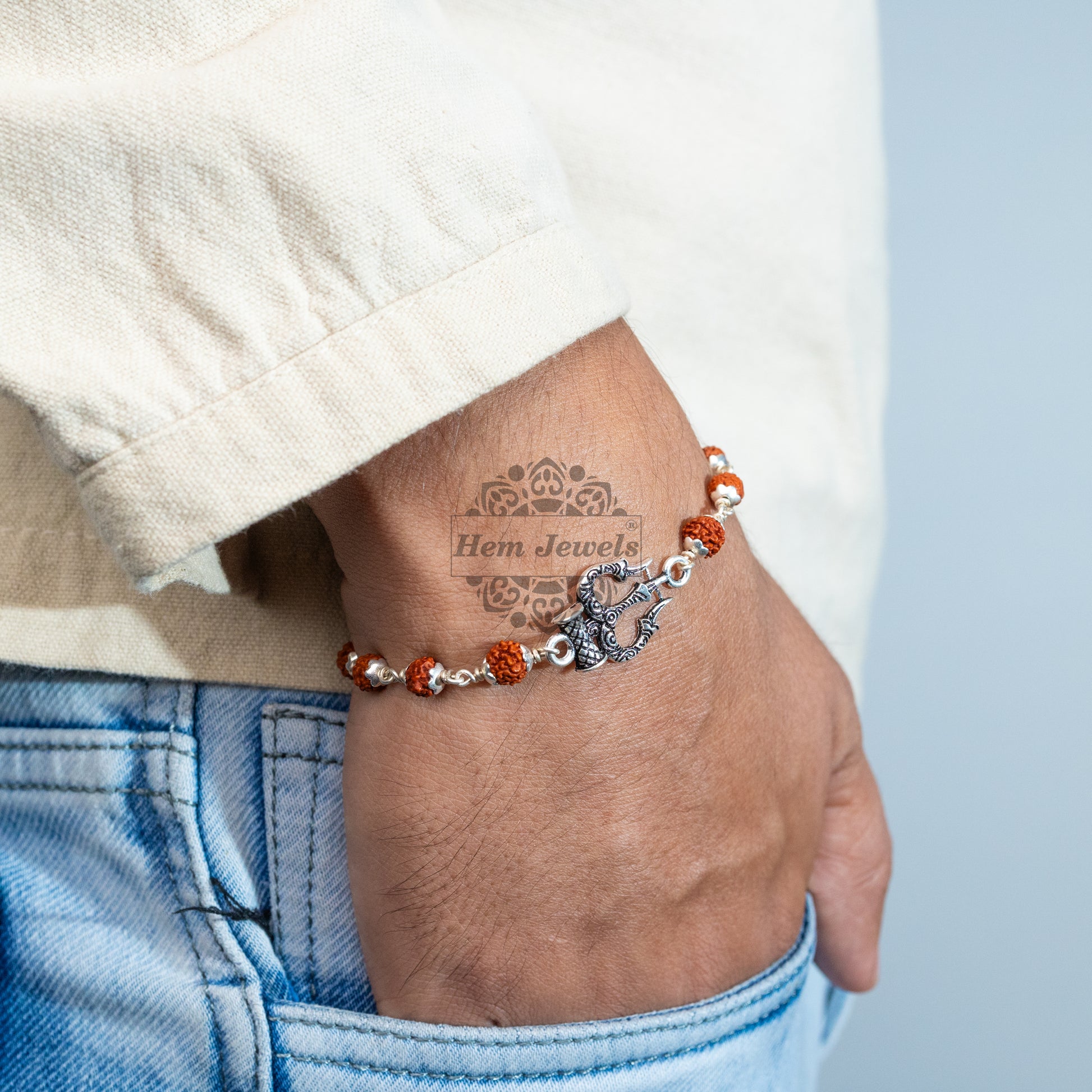 A man Silver Rudraksha Rakhi with Trishul - TridentMotif